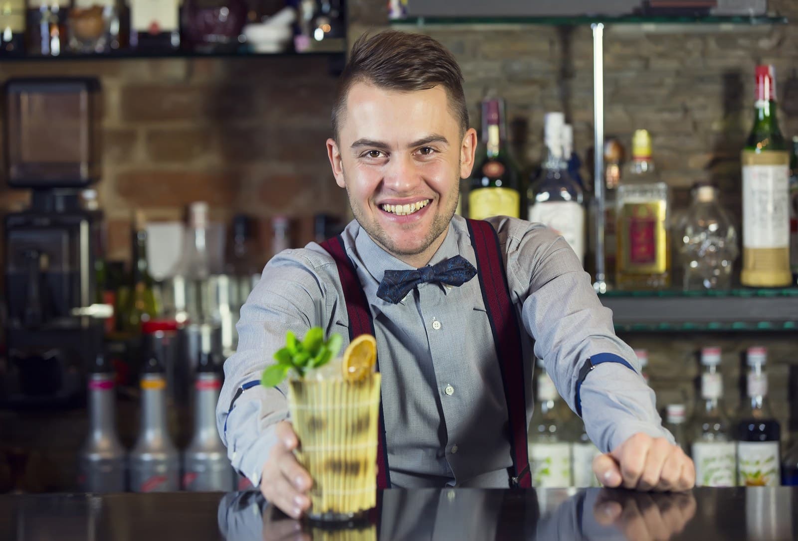 Denver event bartender serving a craft cocktail at a private bar setup